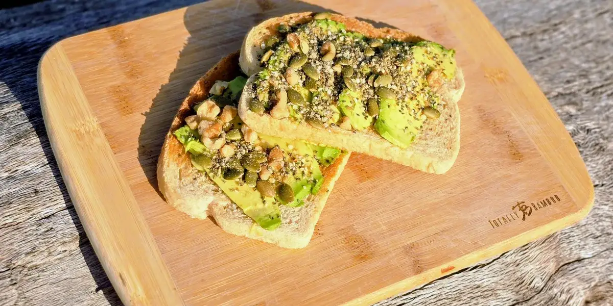A fresh green salad with seed and nut mix sprinkled on top
